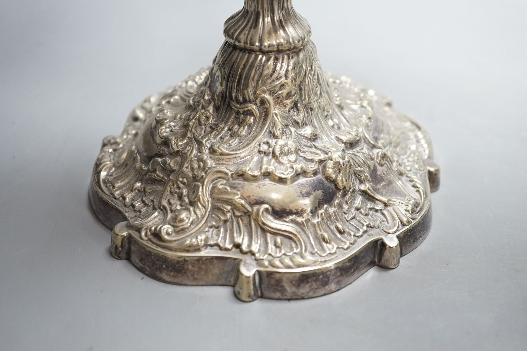 A pair of plated embossed three branch candelabra, 43cm